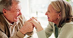 Senior couple, holding hands and happy in conversation with smile for marriage, love and bonding. Laughing, elderly man and woman with communication at home for connection, care or retirement romance