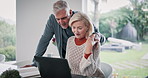 Book, laptop and senior couple with discussion at table for loan payment, financial bills or insurance. Elderly people, retirement and talking at home for pension, healthcare invoice and budgeting