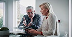 Argue, documents and senior couple on tablet in home for budget, financial review and mortgage payment. Retirement, digital tech and man and woman with bills for insurance, debt and online finance