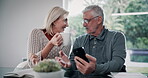 Senior couple, phone and coffee in home with digital website search for retirement planning with care. Chat, love and tea with marriage of people in a living room with communication and tech at table