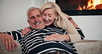 Love, hug and relax with old couple on sofa for romance, retirement and marriage milestone. Happiness, calm and commitment with senior man and woman in living room of home for peace and trust