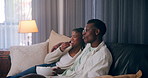 Home, film and black couple on sofa, entertainment and watching tv in living room. African man, woman and rest on couch, comfort and hobby with movie, documentary and relax with fun and relationship