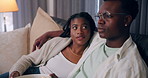 Home, relax and black couple with care, entertainment and watching tv in living room. African man, woman and love on couch, comfortable or hobby with movie, film and series with relationship or break