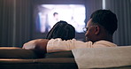 Couple, hug and back for watching tv on sofa with movie, film or streaming show at home. Relax, television and people love in living room with cinema snack, subscription service and weekend break