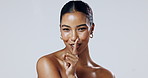 Woman, face and finger with hush, studio and silence for mystery announcement mockup. Model, gossip and beauty secret with rumor, whisper and gesture for news or noise for privacy on white background