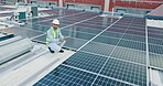 Technician, man and tablet with solar panel on rooftop for renewable energy installation and quality assurance. Power supply, engineer and inspection of photovoltaic grid for safety maintenance test