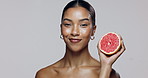 Skincare, fruit and woman in studio, glow and smile for benefits, beauty or confident with product. Spa, white background and portrait of girl with cosmetics, smooth or shine of skin with dermatology