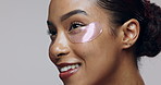 Skincare, happy woman and face in studio with eye mask, beauty and hyaluronic acid treatment. Girl, blowing kiss and patch on skin for hydration, anti aging and dermatology care on gray background