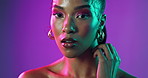 Woman, face and neon in studio for beauty, makeup and cosmetics with cyberpunk aesthetic. Person, portrait and confident on purple background with luxury accessories, unique hairstyle and light glow