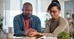 Religion, couple and bible by man and woman holding hands and praying for peace, worship or faith with coffee. Family, God and people with prayer, christianity or Jesus Christ praise together in home