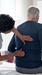 Senior man, physiotherapist and back pain with woman for recovery, massage or muscle development. Elderly patient, physical therapy and helping hand for rehabilitation, injury and wellness at clinic