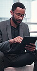 Business, black man and relax by typing on tablet for project research, update schedule and reading report. African, male person and glasses with digital to review email, feedback information and app