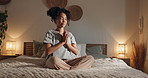 Woman, yoga and namaste on bed, home and happy with peace, mindfulness and relax in pyjamas at night. Girl, person and smile with meditation, lotus and balance with breathing in bedroom at apartment