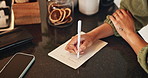 Home, hands and person with paper for grocery list, planning and writing items for shopping by above. Kitchen counter, female writer and page with pen for house needs, reminder and brainstorming