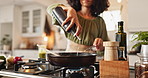 Cooking, hands and woman in kitchen for lunch, food and chef at counter with fresh recipe. Diet, wellness and girl at stove for meal prep with olive oil, nutrition and dinner process in pan at home