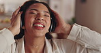 Happy woman, relax and listening with headphones to music for audio streaming, song or vibe at home. Young, energy or calm female person with smile in joy for podcast, radio or sound track at house