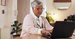 Senior, woman and typing on laptop in home for life insurance policy, legal contract and retirement plan. Technology, person and research at table for title deed, application form or asset management