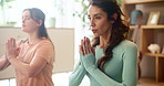 Women, friends and yoga on floor in home with namaste, health and breathing exercise with partnership in morning. People, together and mediation for peace, teamwork and wellness with zen at apartment