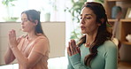 Women, friends and namaste on floor in home for yoga, health and breathing exercise with partnership in morning. People, together and mediation for peace, teamwork and wellness with zen at apartment