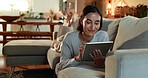 Woman, tablet and smile on sofa in home, relax and reading ebook with subscription on application. Person, digital touchscreen and happy for notification, click and streaming video on couch in house