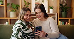 Woman, mature mom and phone on sofa, reading and smile for notification, video or memory at apartment. People, mother and daughter on smartphone, search and laugh with mobile app for bonding in home