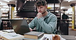 Student, thinking and man in library, laptop and typing with education, university and knowledge. College, person and guy with computer, studying and research for project, network and problem solving