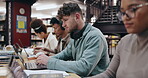 Research, learning and laptop with man in library for knowledge, education and college thesis. Academy, future and university portal with students and studying for exam, project and scholarship