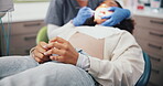 Woman hands, stress and dentist in office for surgery, procedure and cavity inspection. Patient, orthodontist and anxiety in practice for root canal, oral care and consultation for tooth removal