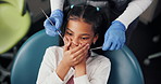 Child, scared and dentist hands in office for surgery, procedure and cavity inspection. Patient, orthodontist and anxiety in practice for dental tools, oral care and consultation for tooth removal