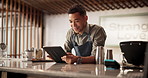 Bartender, man and tablet at bar, reading and inspection for stock, happy and inventory at small business. Person, entrepreneur and touchscreen with application, check and notification at restaurant