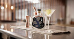 Bottle, drinks and martini in glass for mixology, alcohol and hospitality with catering in club. Counter, luxury and cocktail in hotel for happy hour, preparation or professional person with lemon