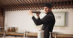 Man, bartender and cocktail shaker for drink preparation, beverage or mixology process. Pub, mixer and barman shaking alcohol ingredients for liquor, professional service and catering at restaurant