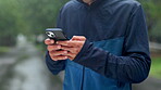 Hands, phone and man at park for fitness app, scroll results and check training progress. Mobile, sports and runner closeup outdoor for health info, location search and update schedule on internet