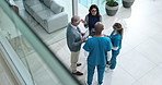 Woman, doctors and discussion in lobby at hospital with paperwork, tablet and above for healthcare service. Clinic director, staff and team in scrum for meeting with documents, feedback or inspection