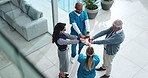 People, doctors and fist bump in lobby at clinic with support, motivation or above for health services. Hospital director, staff and team in scrum for meeting with cheers, celebration and diversity