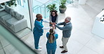 People, doctors and stack hands at clinic in in lobby with support, goals or above for health services. Hospital director, staff and group in scrum for applause with cheers, celebration and diversity