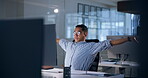 Computer, night and yawn with business man at desk in office for administration or deadline. Thinking, planning and stretching with tired design employee at creative workplace in late evening