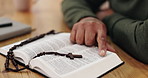 Bible, reading and hands of mature person in home for gospel lesson, learning and spiritual belief. Religion, Christianity and closeup of holy book for scripture, worship and praying for faith in God