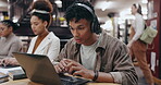 Man, reading and headphones with laptop in library for typing assignment essay, study music or exam research. University, group or student with technology for online course, radio audio and education