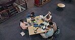 Above, people and laptop in library for education, studying and research for exam preparation. Students, group and tech at table for information, productivity and reading with notes in university