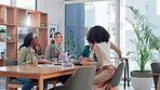 Group, meeting and women in boardroom, smile and discussion with paperwork, business or creative. Morning, talking and person with headset for sales, happy and computer for customer service or office