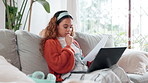 Woman, sofa and thinking on laptop with paperwork at home for research and remote work as copywriter. Female person, freelancer and reading with document for creative writing and book editing