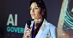 Stage, woman and business speaker in seminar for ai data governance, ethical guidelines and training conference. Professional, person and discussion with mic in international summit for compliance