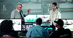 Security, man and woman in control room for meeting, planning defence strategy and satellite video on screen. Government, digital surveillance and team leader in command center at intelligence agency