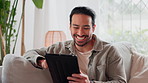 Home, funny and man with tablet, typing and internet for social media, connection and texting. Happy person, apartment and laughing on couch, technology or digital app for email, chatting and message