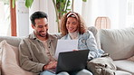 Happy, interracial couple or laptop with bills on sofa for finance, payment or mortgage together at home. Young, man or woman with smile on computer for invoice, budget or financial planning at house