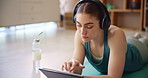 Girl, relax and headphones with tablet for music, home workout or fitness on exercise mat. Female person, tech and streaming for wellness, gym or training for rest in house for health, balance or zen