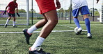 Football, team legs and match on field for challenge, game or competitive tournament. Men, soccer players or sport at community outreach program for action, training or technique on grass at facility