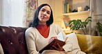 Woman, sofa and writing with diary, book and thinking with planning, ideas or inspiration for future in living room. Person, notebook and reflection with notes, journal or memory on couch in house