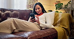 Home, phone and woman relax on sofa for online chatting, social media and contact on weekend. Chill, happy and person resting with smartphone for internet, website and communication in living room